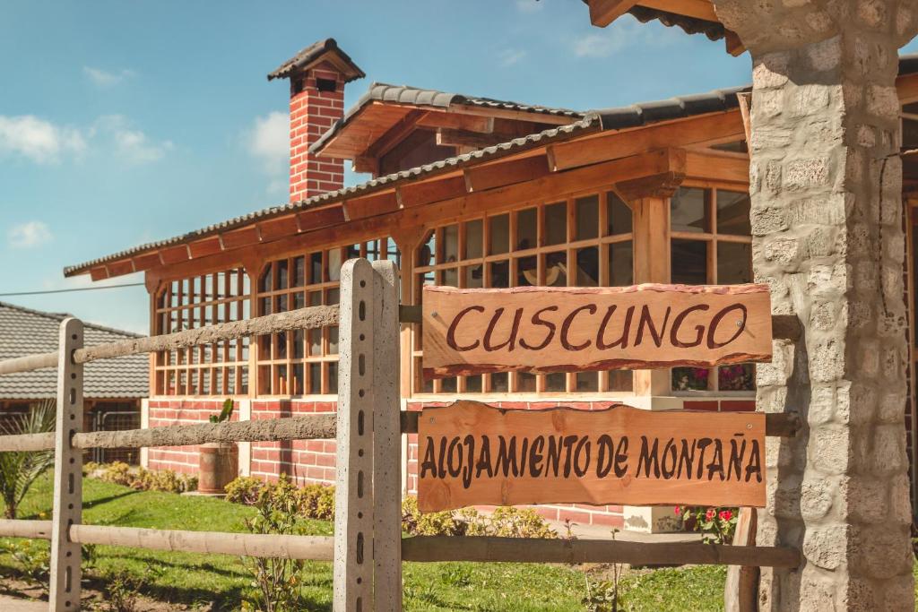 ChasquiCuscungo Cotopaxi Hostel & Lodge的木头建筑前的标志