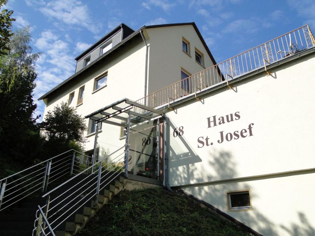 法伦达尔Haus St. Josef的白色的建筑,有楼梯通往