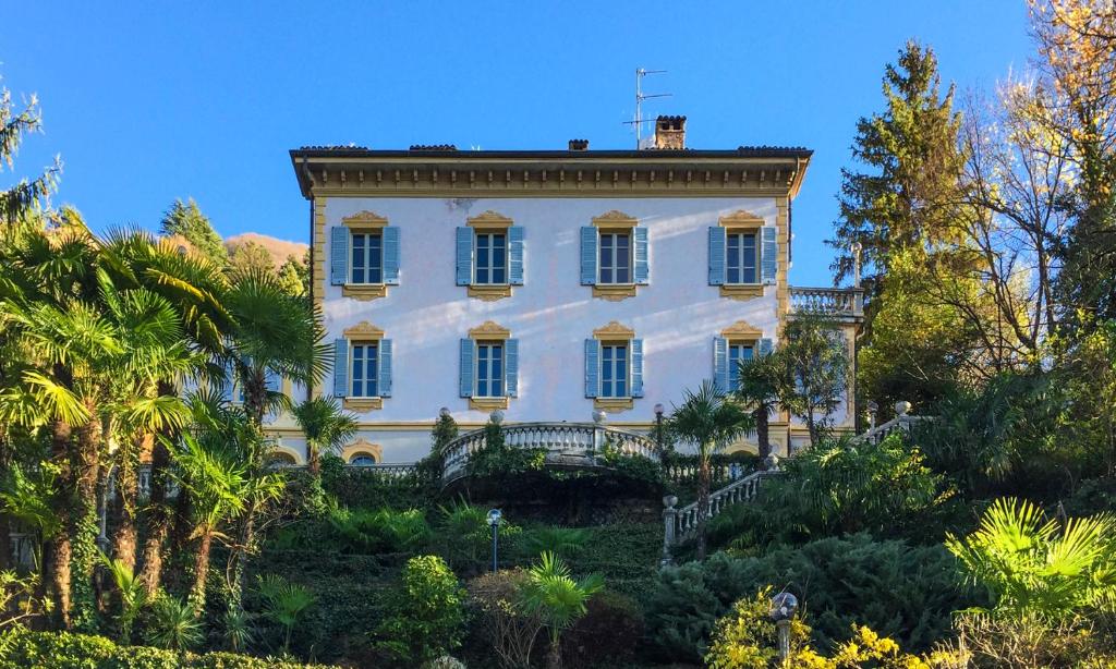 布里维奥B&B Villa Costanza的一座树木茂密的山丘上的白色大房子