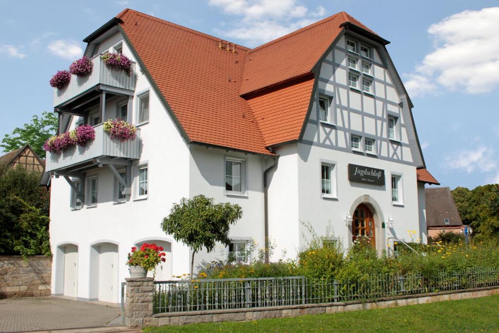 温德尔斯巴赫Landhotel Jagdschloss的白色建筑,有橙色屋顶