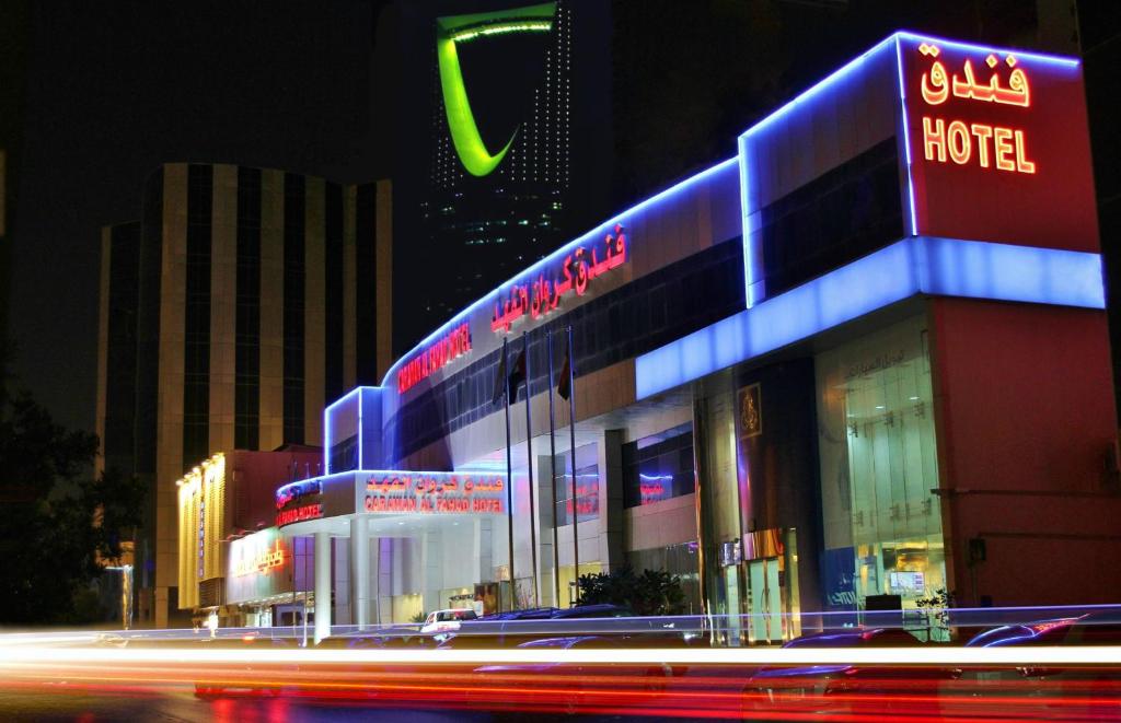 利雅德卡拉万阿尔法赫德酒店的建筑的侧面有 ⁇ 虹灯标志