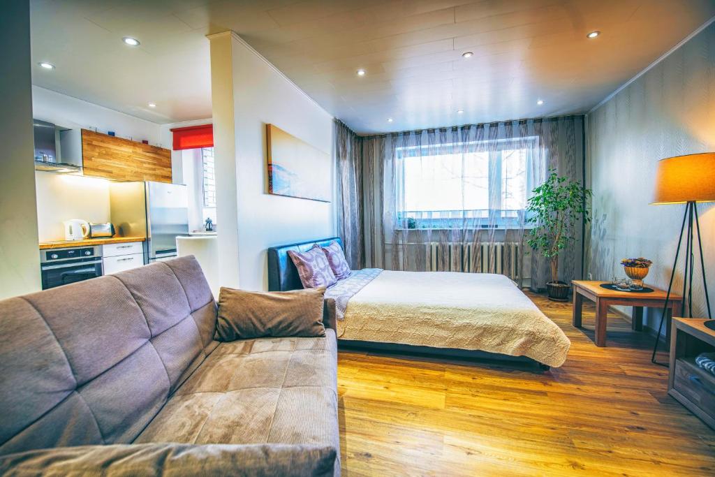 哈普萨卢Simoone Kesklinna Apartment的一间卧室配有一张床和一个沙发