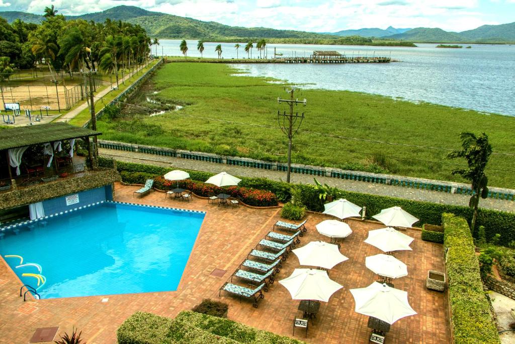 安东尼娜Hotel Camboa Antonina - PR的享有带遮阳伞的游泳池的顶部景致