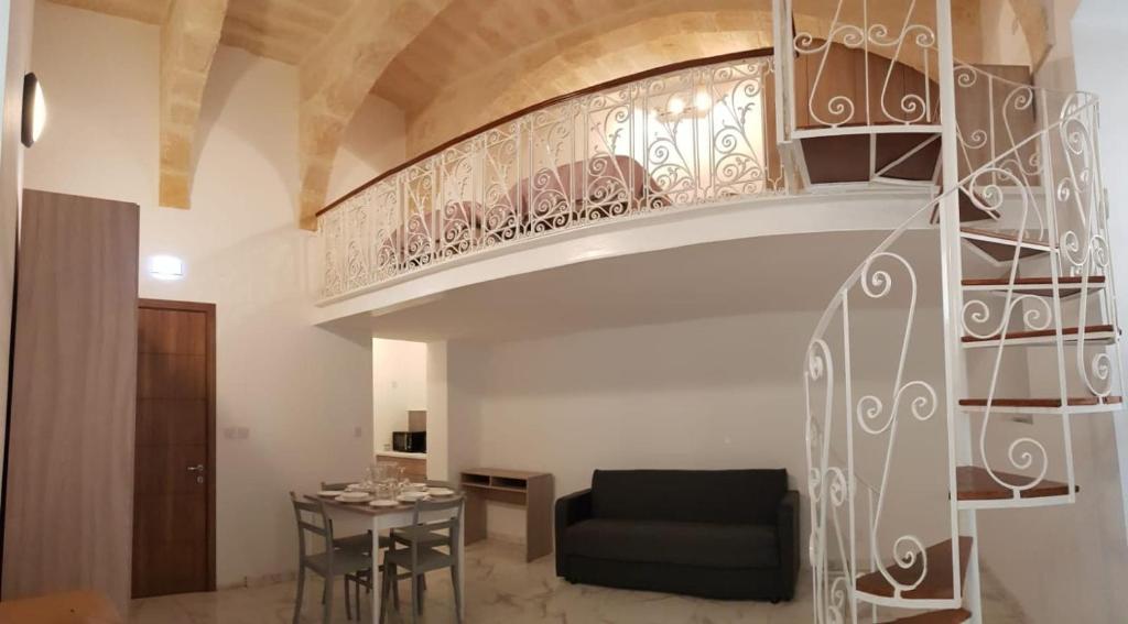 弗洛里亚纳Palazzo Leonardo的客厅的螺旋楼梯,配有沙发和桌子