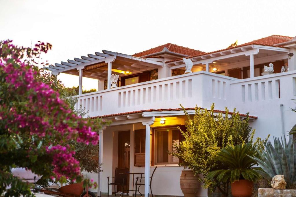 斯特尼瓦拉阿奥索斯Anatoli Villa的前面有粉红色花的白色房子