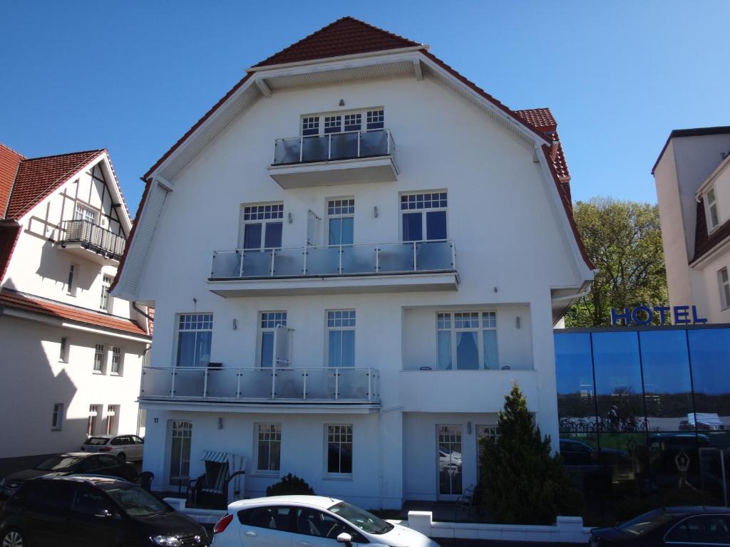 瓦尔内明德Residenz am Strande的一座白色的建筑,上面设有一个阳台