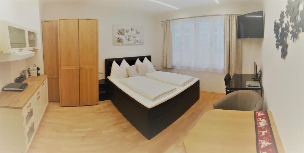 维也纳Vienna City Apartment in Mariahilfer Straße的卧室配有一张床铺,位于带桌子的房间