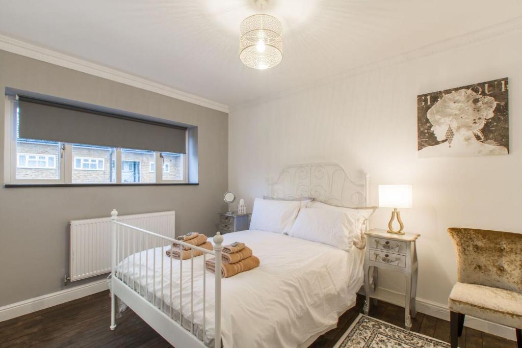 伦敦Luxury London Apartment的卧室配有白色的床和窗户。