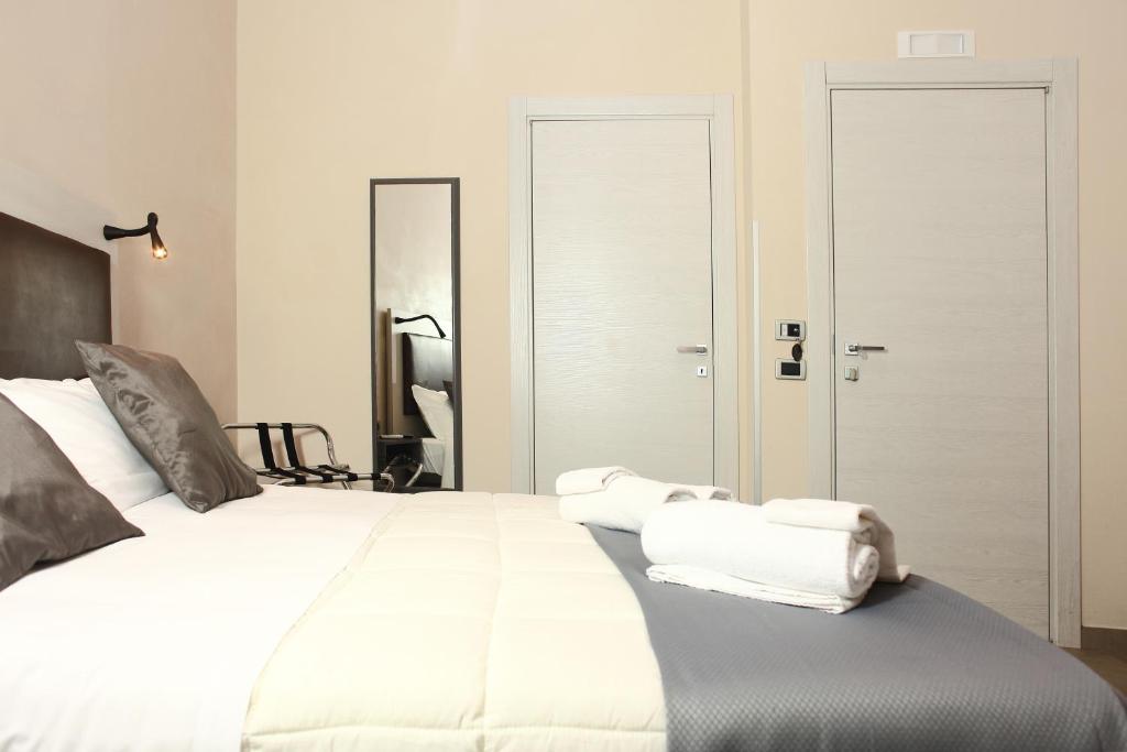 特拉帕尼马克塔酒店的卧室配有带毛巾的大型白色床