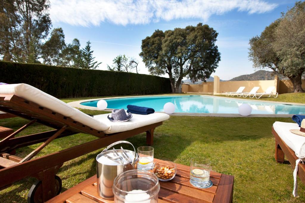 San Justo DesvernVilla Gaudi的后院设有游泳池和带桌子的桌子