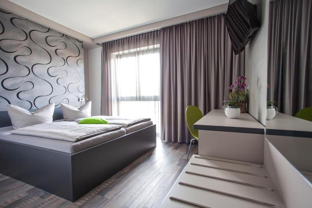 耶拿Hotel Eulensteins的一间卧室配有一张床和一张书桌