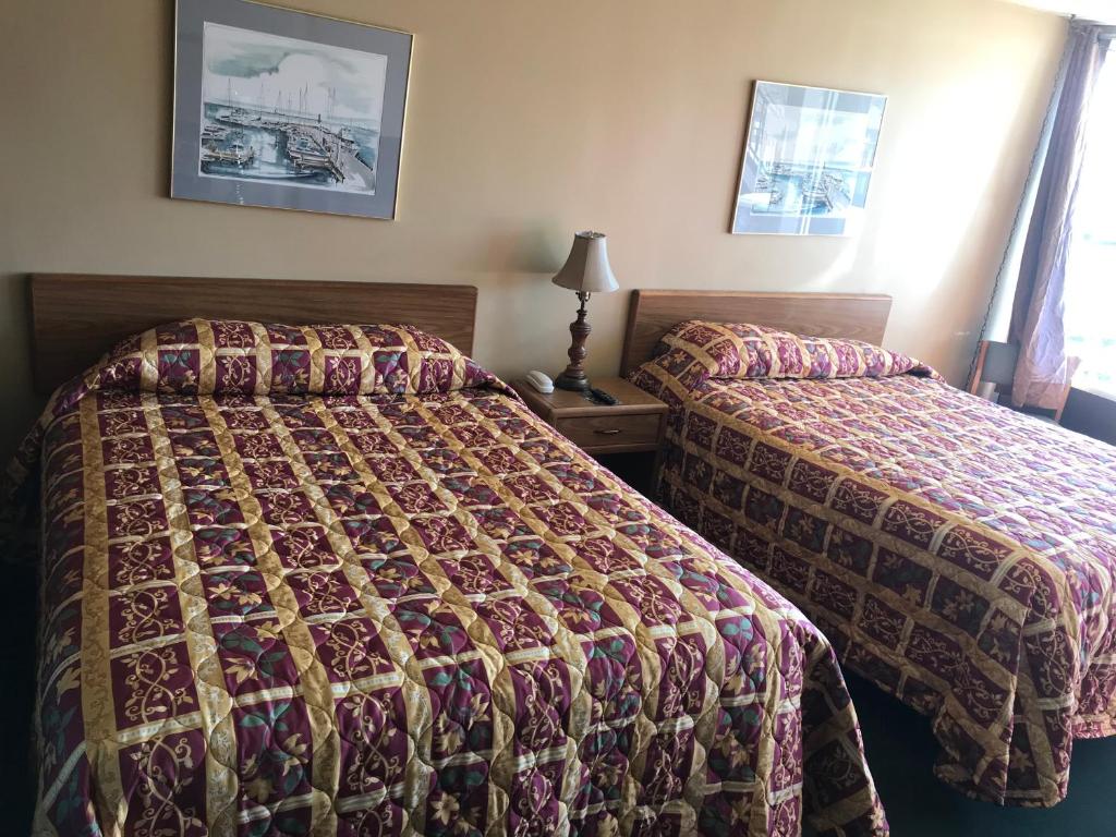 柯克斯维尔乡村汽车旅馆的酒店客房,设有两张床和一盏灯