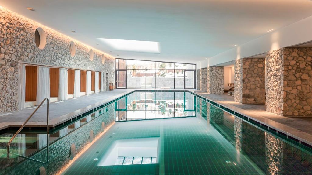 科尔蒂纳丹佩佐法洛里亚山Spa度假酒店的游泳池,位于带游泳池的建筑内