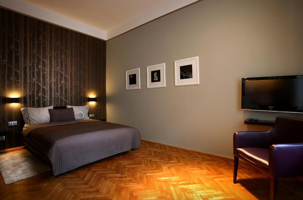 布达佩斯布达佩斯市中心门户酒店的一间卧室配有一张床和一台平面电视