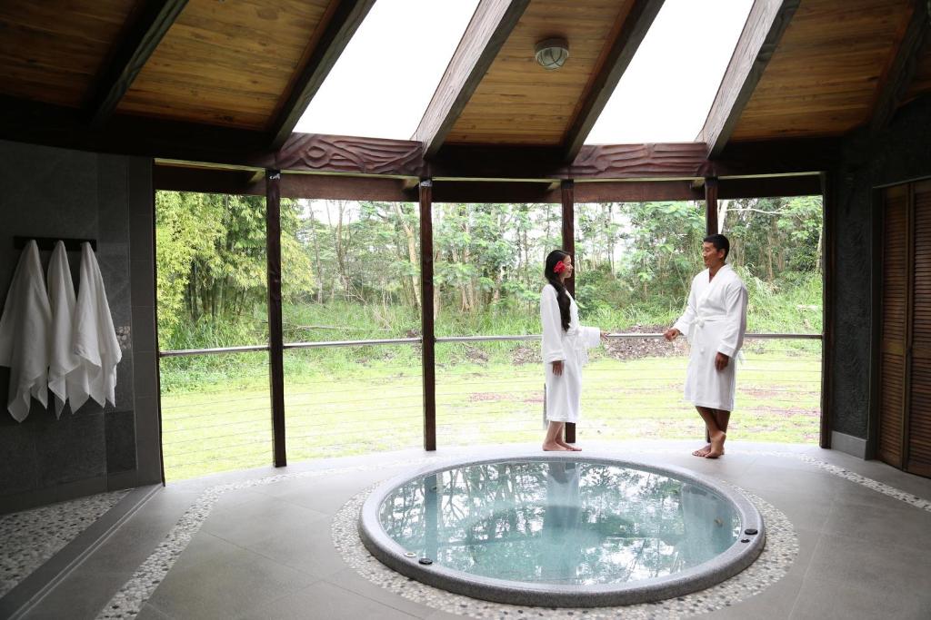 帕霍阿Hawaiian Sanctuary Eco Retreat Center的两人站在浴缸前