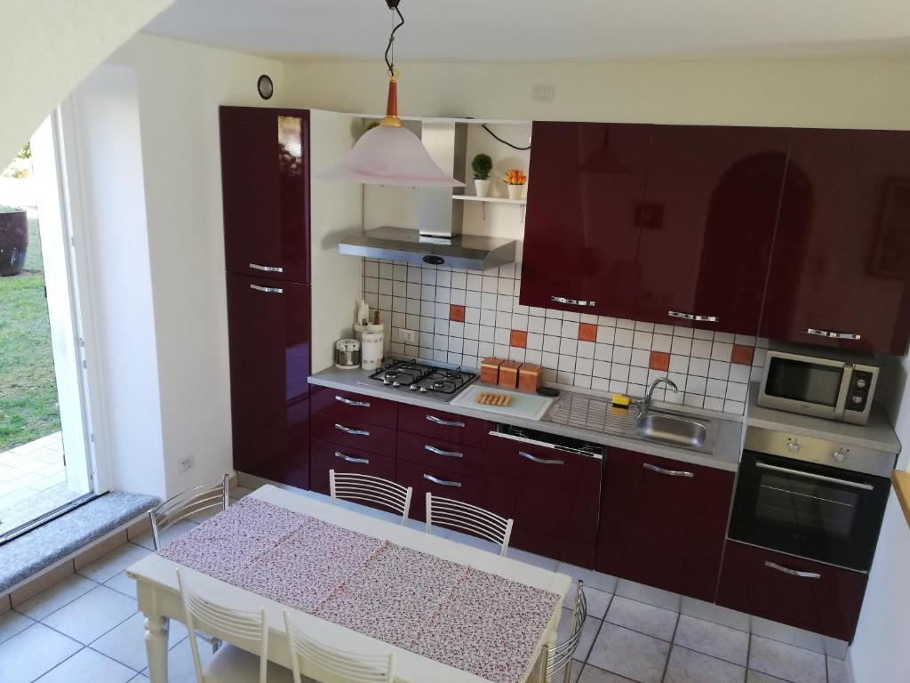 瓦尔博若纳卡萨加布里度假屋的厨房配有棕色橱柜和桌椅