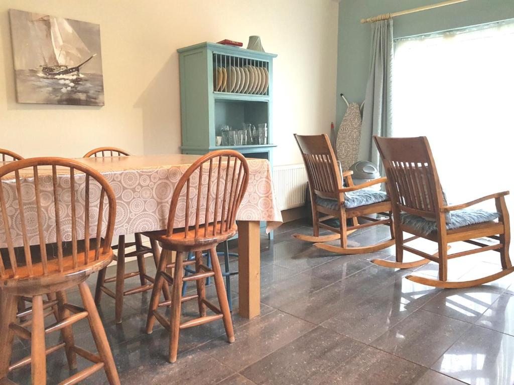 基拉尼Ethan Cottage的一间带桌子和四把椅子的用餐室
