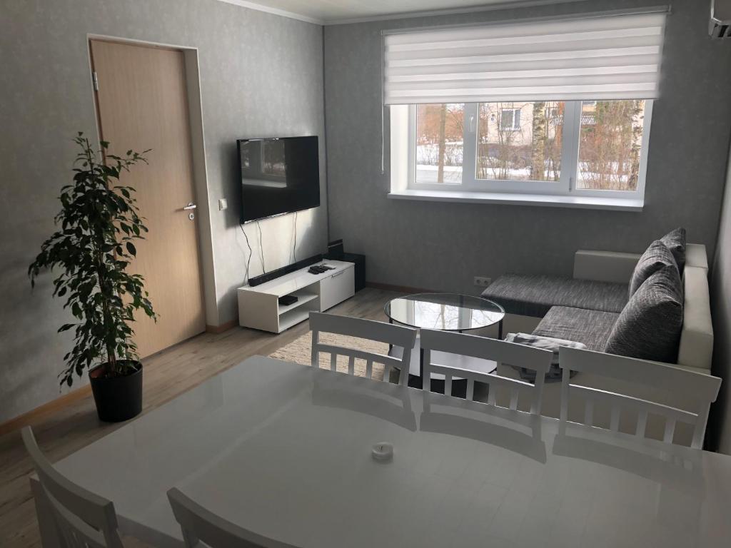 MikitamÃ¤eSoelaane 12 Apartments的客厅配有桌子和沙发