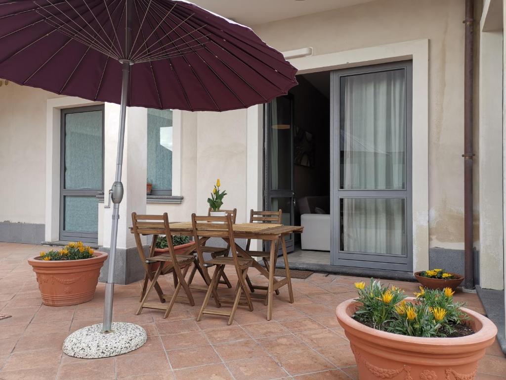 扎费拉纳-埃特内阿Floris Home tra Mare e Montagna的庭院里配有桌椅和遮阳伞