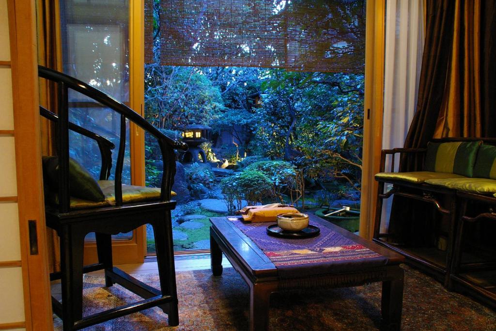 京都晴鸭楼日式旅馆的客房设有桌子、椅子和窗户。