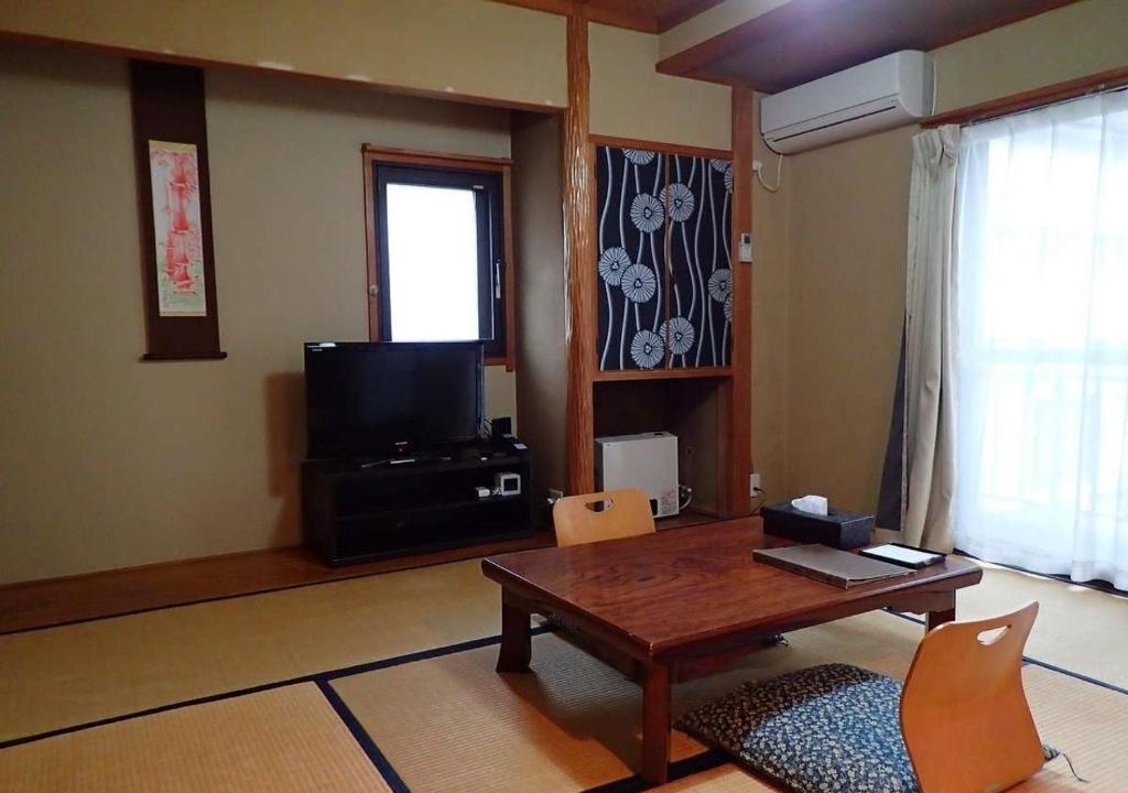 野沢Address Nozawa Japanese Room / Vacation STAY 22751的客厅配有桌子和电视
