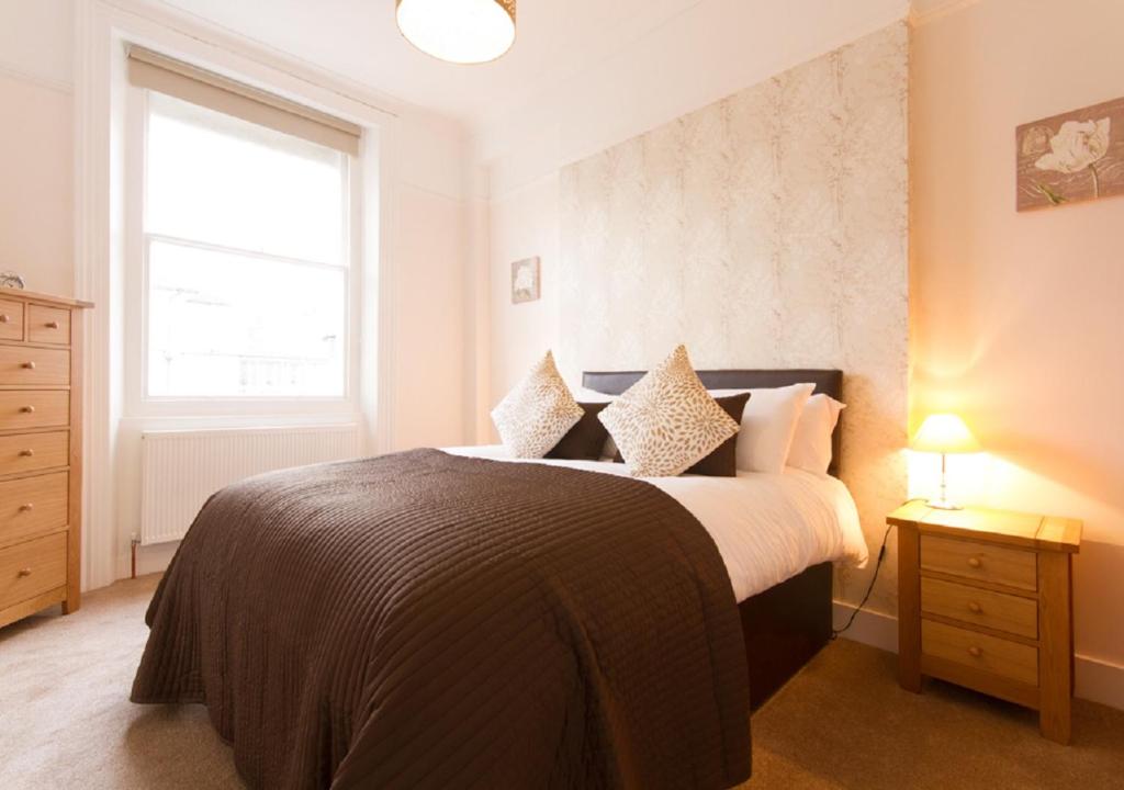 伊斯特布恩Thorne Lodge的一间卧室设有一张大床和一个窗户。