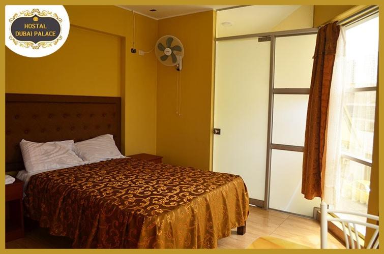 利马Dubai Palace的一间卧室设有一张床、一个窗口和风扇