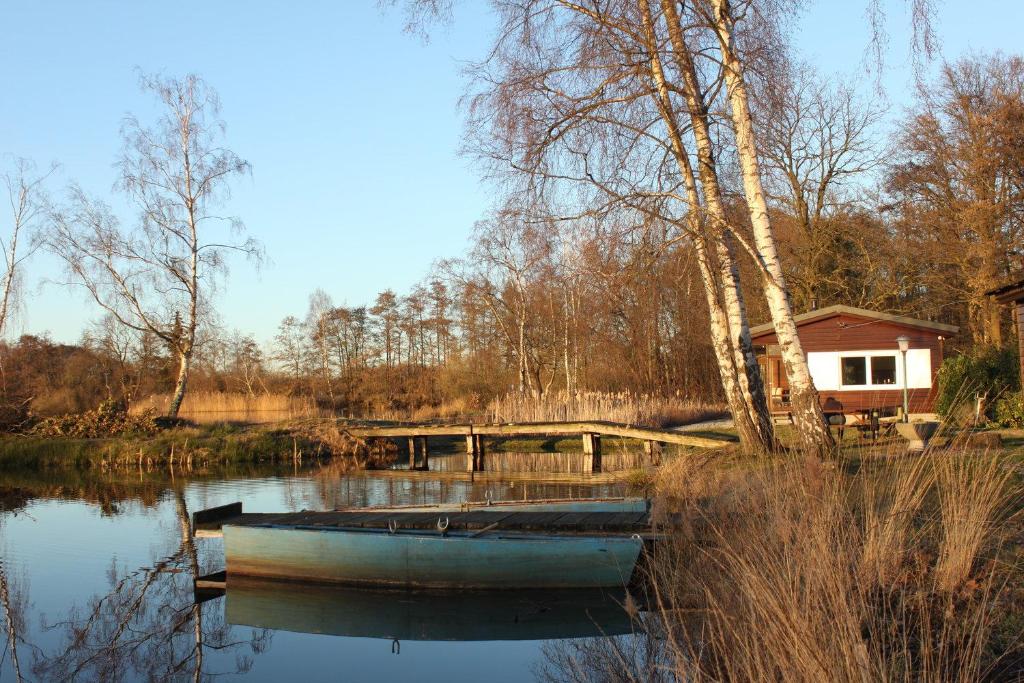 DiepenbeekMy Secret Garden的坐在房子旁边的水中的小船