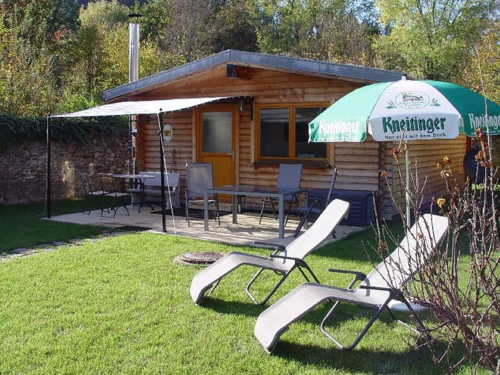 苏尔茨堡Haus Weichart的小屋配有桌椅和雨伞