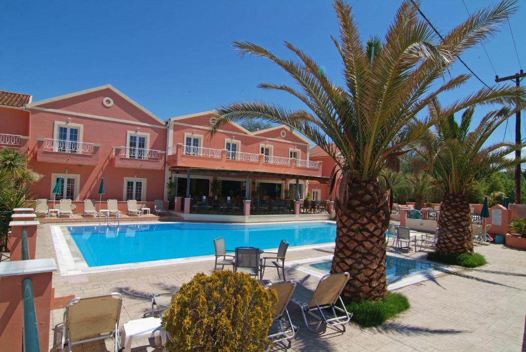 斯达林Joy Hotel的一个带游泳池、棕榈树和椅子的度假酒店