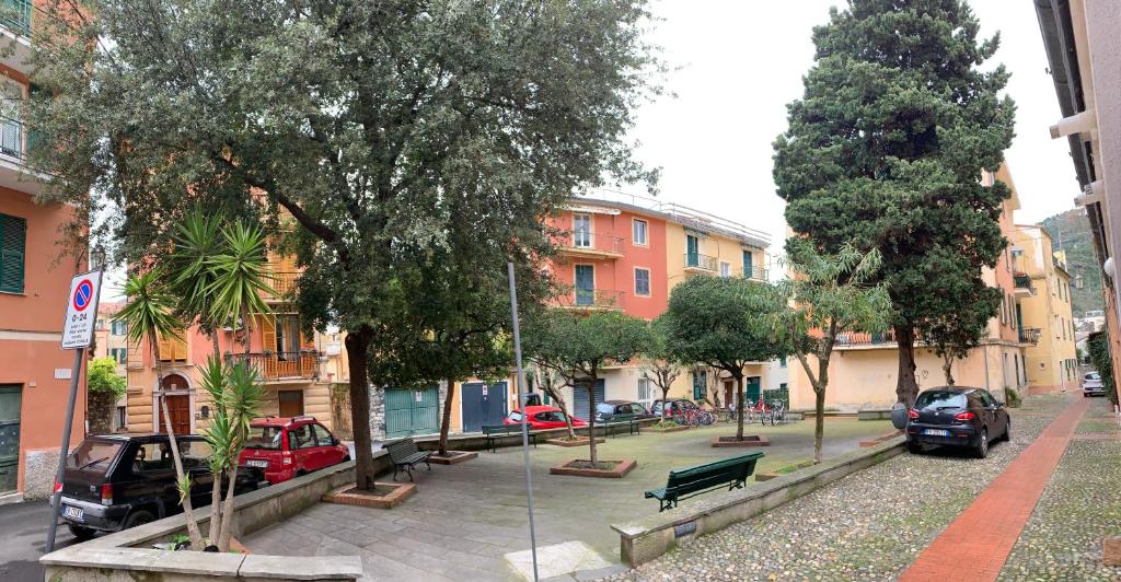 莱万托Ca du Sergio - Il Mesco的一条城市街道,有停车的汽车,树木和建筑
