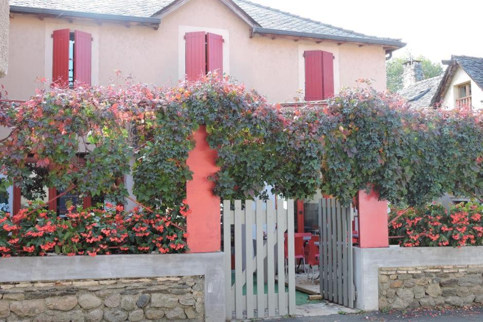 Ispagnac拉斯维吉内罗吉斯酒店的围栏前有鲜花的房子