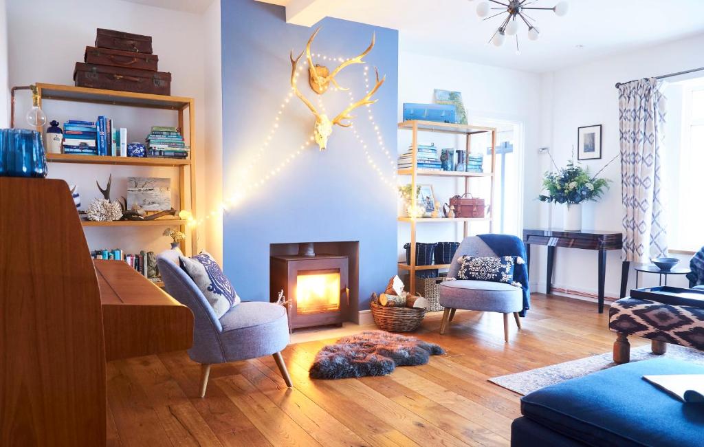 奇切斯特Bell Lodge的客厅设有壁炉和蓝色的墙壁。