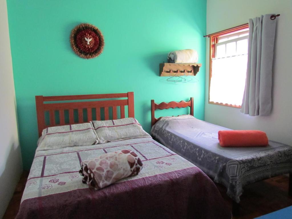 蒂拉登特斯Hostel Lumiar da Serra的卧室内两张并排的床