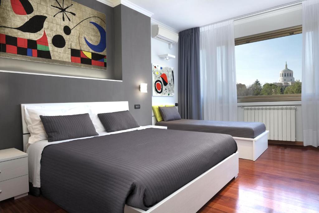 罗马J24住宿加早餐旅馆的一间卧室设有两张床和大窗户
