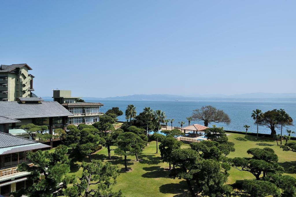 指宿市Kagoshima Sunamushionsen Ibusuki Hakusuikan的享有树木和海洋的度假胜地的空中景致