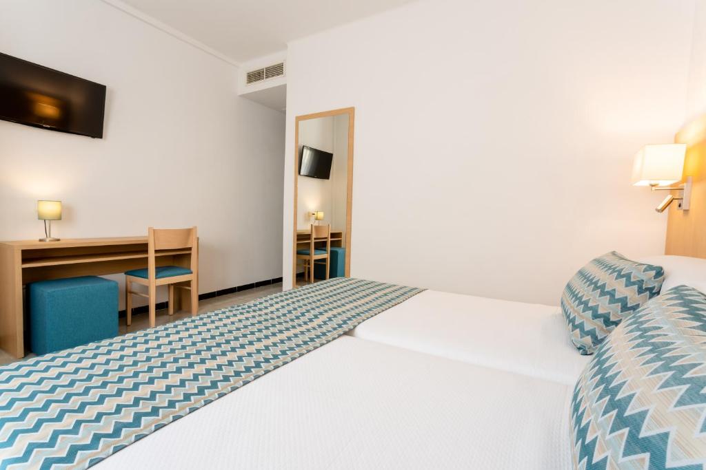 埃尔阿雷纳尔瑞陶特酒店的配有一张床和一张书桌的酒店客房