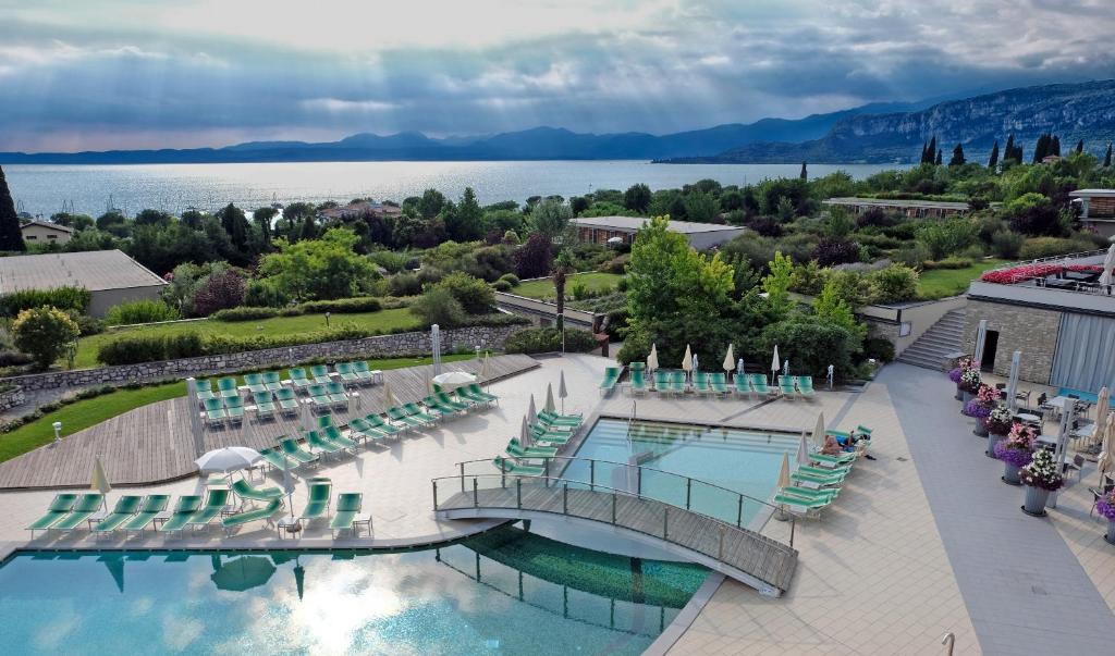 巴多利诺Parc Hotel Germano Suites & Apartments的享有带游泳池和椅子的度假村的空中景致