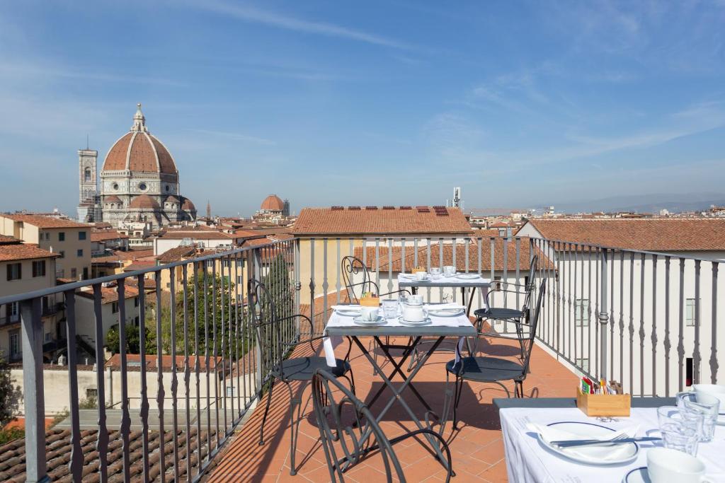 佛罗伦萨格拉齐亚尼宫住宿加早餐旅馆的阳台设有两张桌子,享有城市美景
