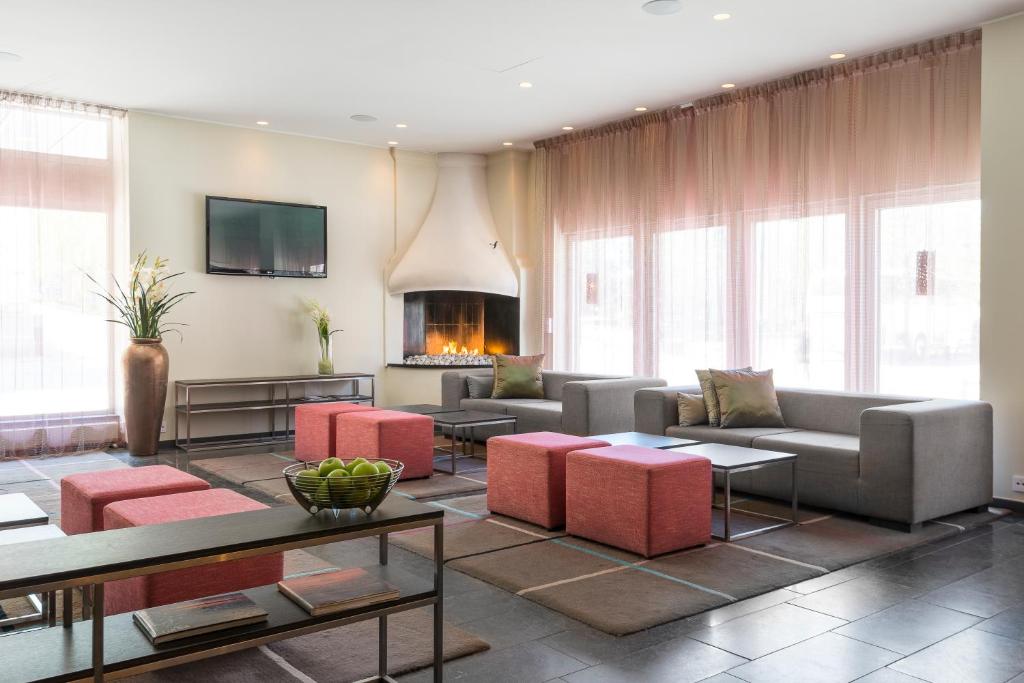 吕勒奥吕勒奥品质酒店的带沙发和桌子的客厅以及壁炉。
