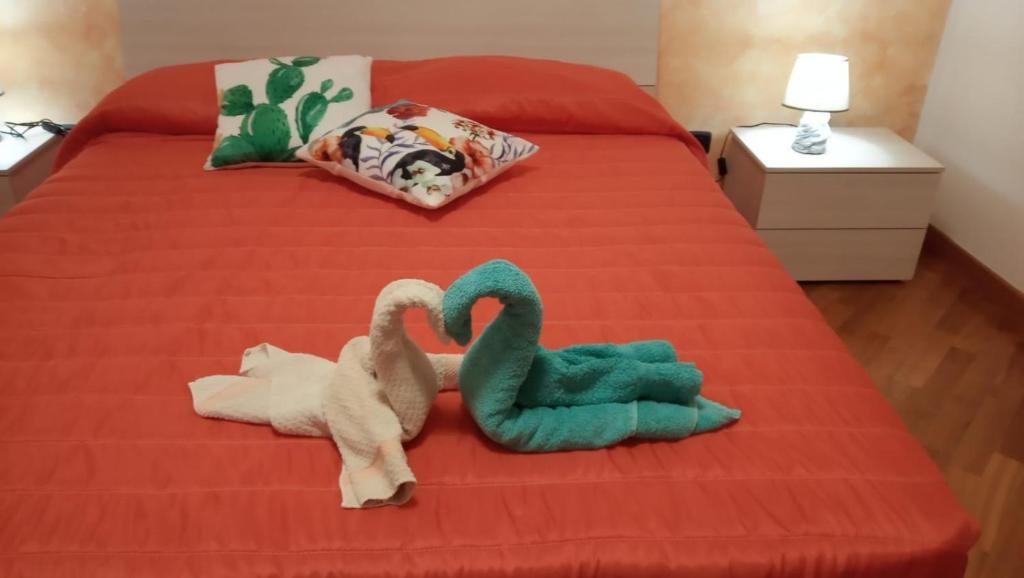 马焦内Appartamento I Molini的一张床上有两个塞满天鹅的睡床