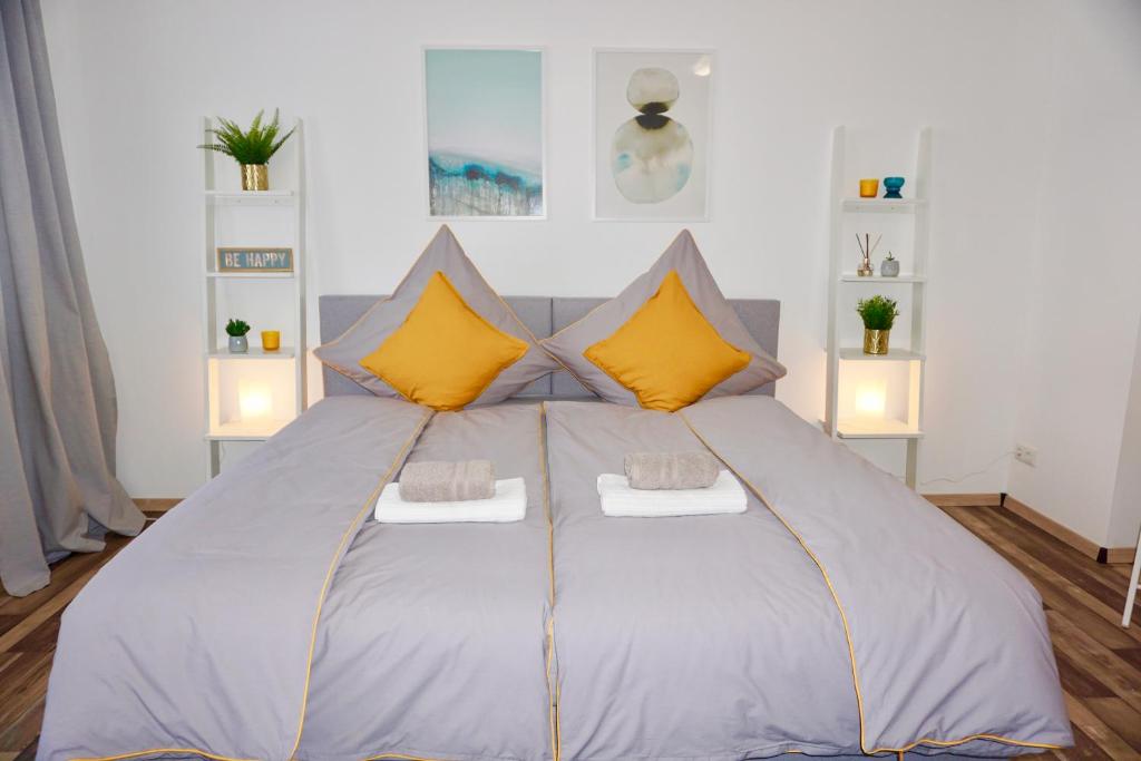 柯尼希斯布伦MH Apartment的一间卧室配有一张带黄色枕头的大床