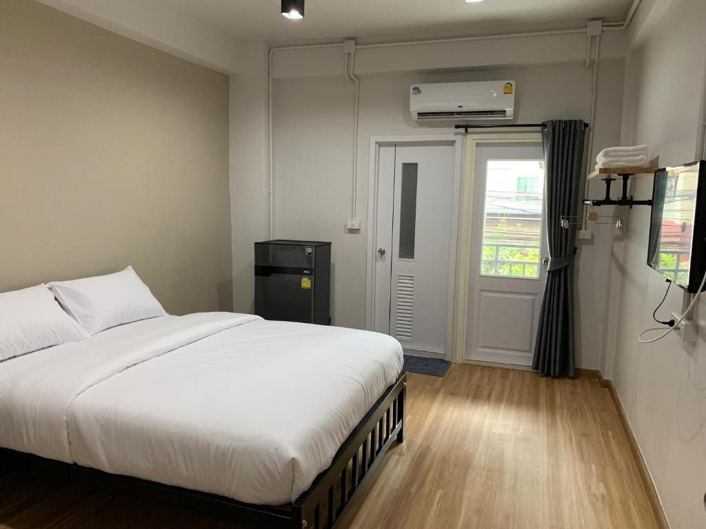 曼谷9TY hotel (ninety hotel)的卧室设有一张白色大床和一扇窗户。