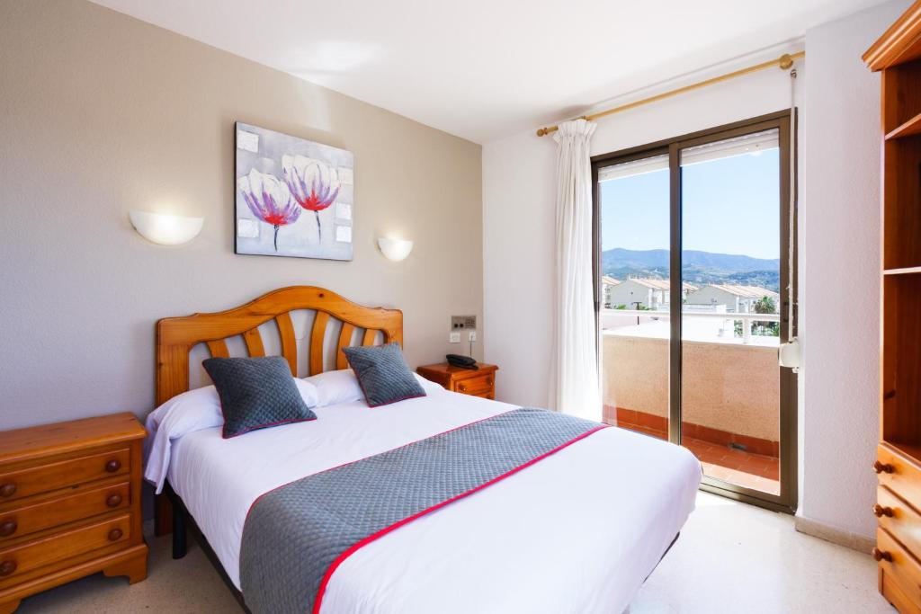 莫特里尔Hotel Costa Andaluza的一间卧室设有一张床和一个大窗户