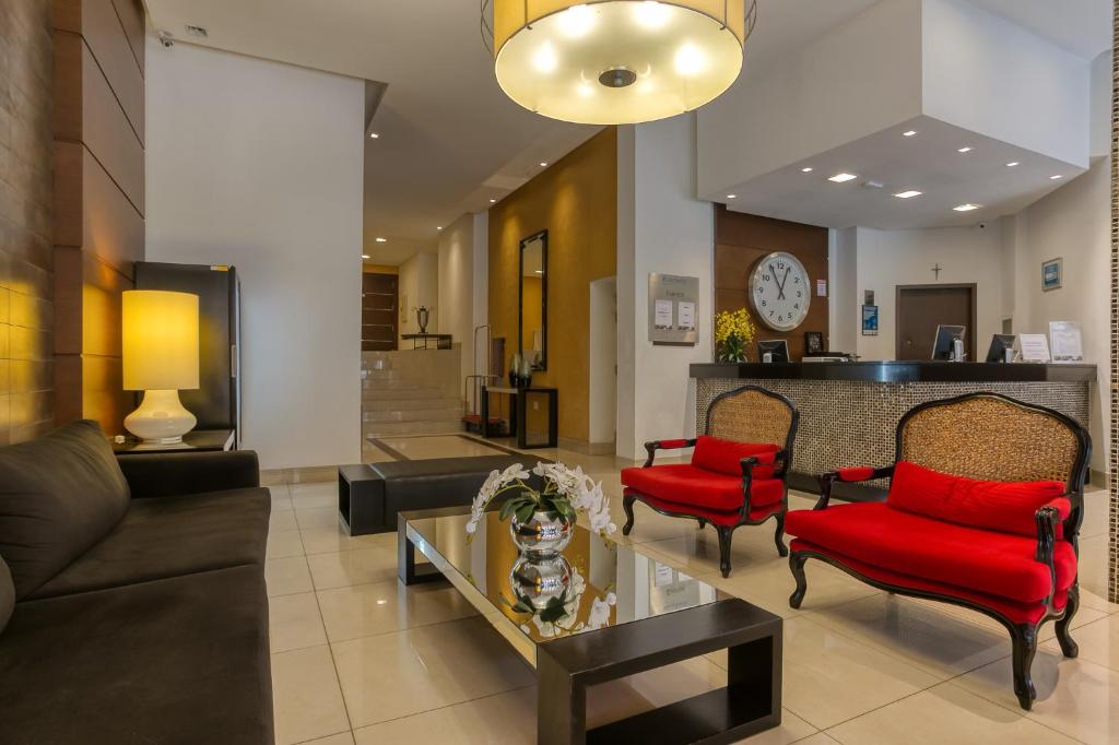 库里提巴Roochelle Hotel by Nobile的带沙发和红色椅子的客厅