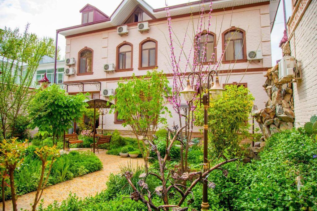 撒马尔罕普拉坦酒店的房屋前的花园
