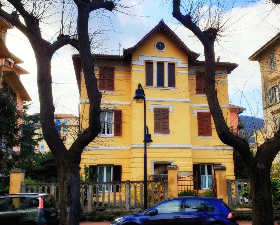 莱万托Edera的一座黄色的房子,前面有汽车停放
