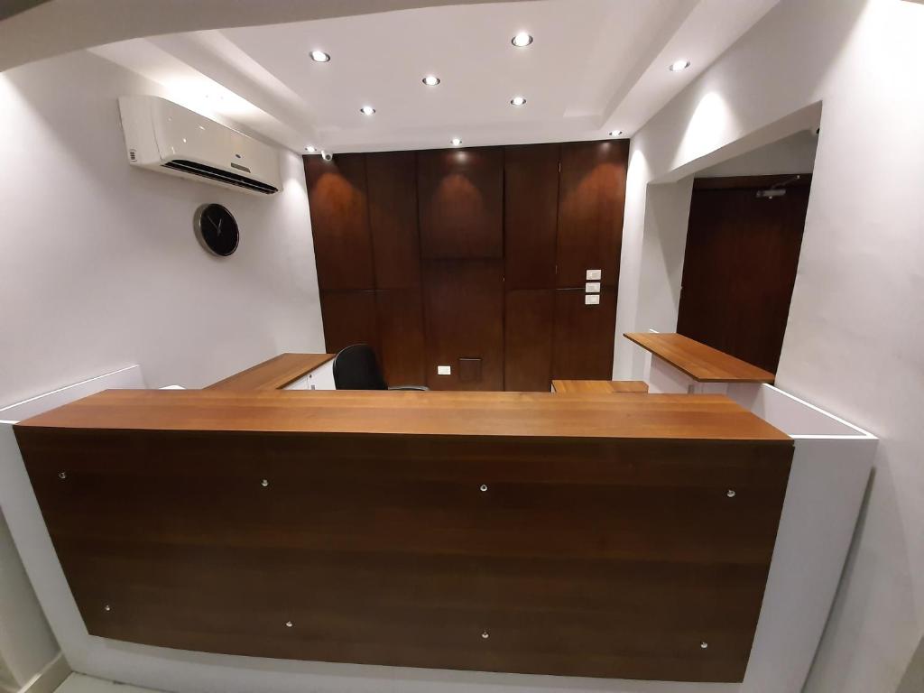 开罗Nakhil Inn Residence的一个带木桌和镜子的办公室