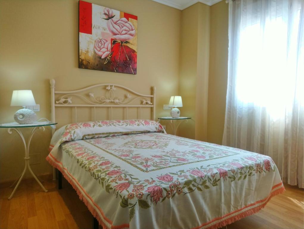 利洛La Casa Periquita的一间卧室配有一张床,窗户配有绘画作品