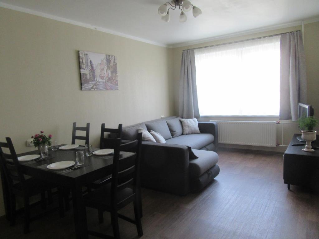 里加Family Apartment的客厅配有沙发和桌子